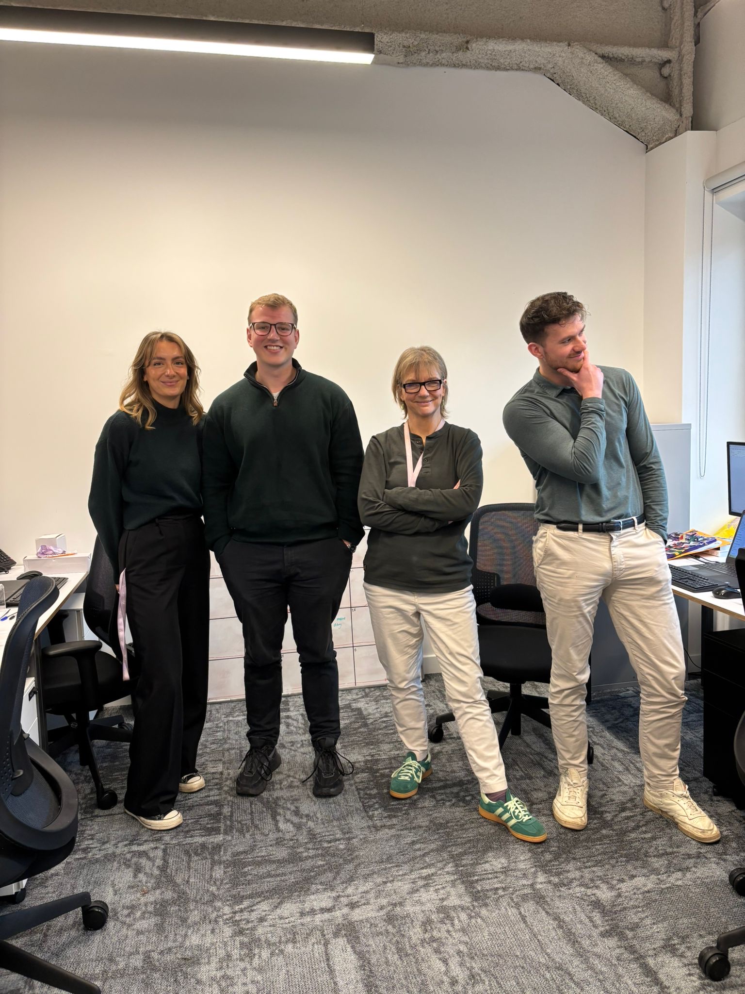 four of the energyr pr team wearing green in the office